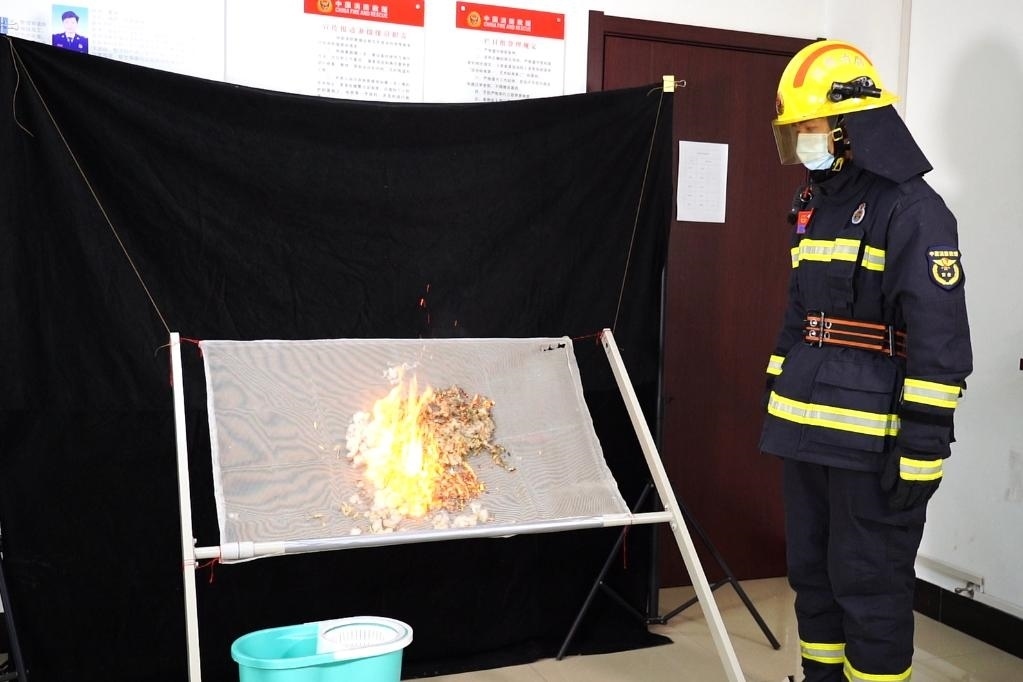 消防員在展示柳絮點燃實驗。 張少欣 攝