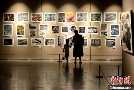 圖為家長帶著孩子參觀展覽。呂明 攝