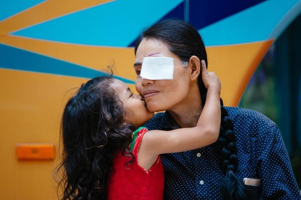 2019年3月15日，在柬埔寨磅湛省醫(yī)院，即將接受白內(nèi)障手術(shù)的患者孫美樂接受女兒的親吻祝福。在接受了中國醫(yī)療隊(duì)的白內(nèi)障義診手術(shù)后，她的視力逐步恢復(fù)，生活有了新的光明和希望。