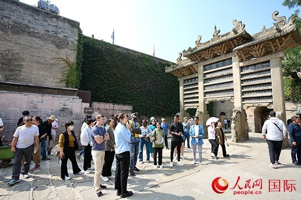 選手們認真聆聽導游講解。人民網(wǎng) 盧鵬宇攝