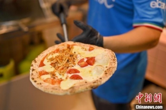 近日，韋榮耀展示他制作的“老友味”披薩。 俞靖 攝