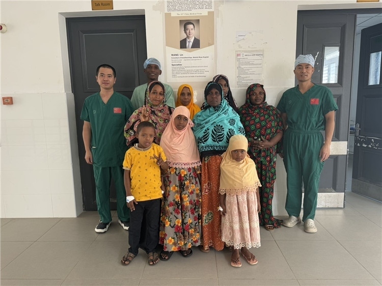 李廣（右一）和王林醫(yī)生與部分患者合影。中國援桑醫(yī)療隊(duì)供圖