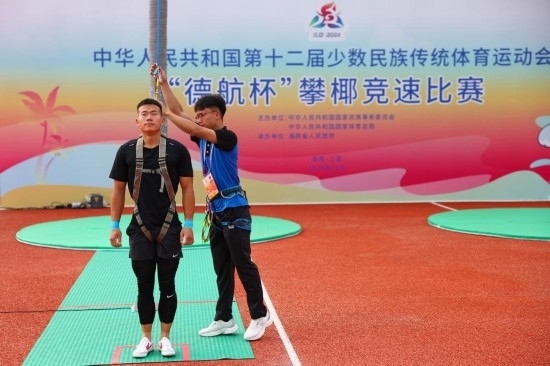 11月23日，工作人員為上海隊(duì)選手付樂(lè)樂(lè)（左）系安全繩。新華社記者 楊植森 攝