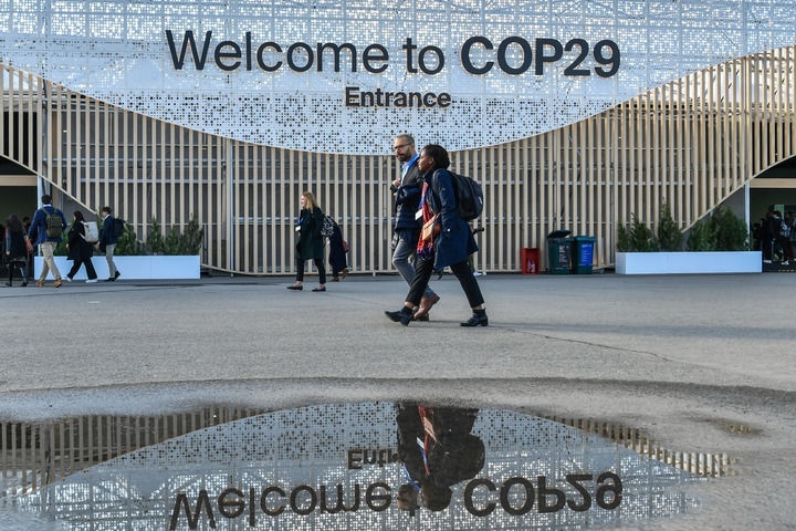 2024年11月15日，在阿塞拜疆首都巴庫，人們經(jīng)過聯(lián)合國氣候變化巴庫大會的會場。新華社記者 曹陽 攝