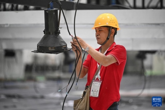 4月4日，工作人員在海南國際會(huì)展中心內(nèi)布設(shè)燈光。