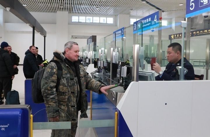 2024年12月10日，在黑河公路口岸旅檢大廳，黑河出入境邊防檢查站民警為首班次客車入境旅客辦理邊檢通關手續(xù)。當日，中國黑河公路口岸—俄羅斯卡尼庫爾干公路口岸旅客運輸正式開通。新華社發(fā)（劉松攝）