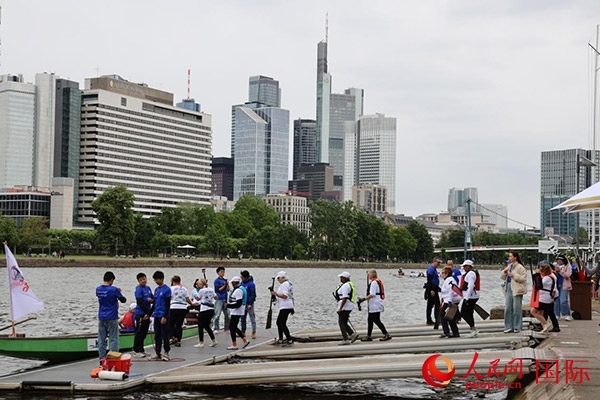 來自美國的快樂龍舟隊(duì)選手們正在登船準(zhǔn)備參賽。人民網(wǎng)記者 劉仲華攝